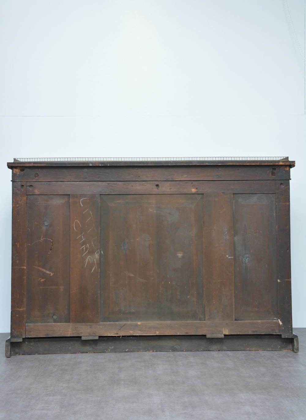 A low George IV rosewood cabinet bookcase featuring a central door with a brass wire mesh grille flanked by two glazed doors, topped with a brass gallery rail. View III