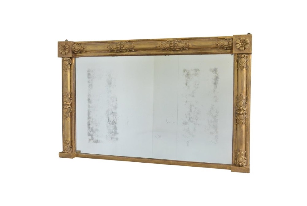 A large 19th-century rectangular giltwood overmantel mirror featuring carved corner rosettes and floral mouldings. View II