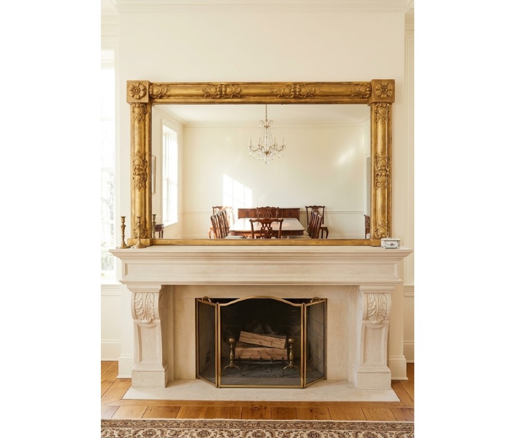 A large 19th-century rectangular giltwood overmantel mirror featuring carved corner rosettes and floral mouldings.