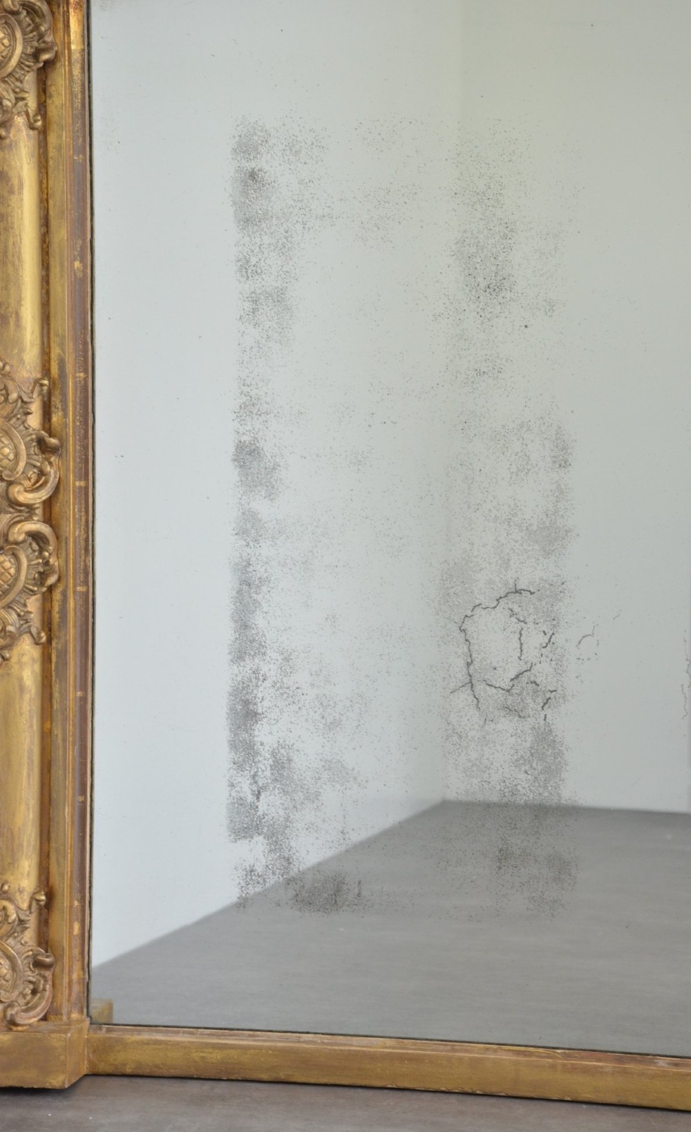 A large 19th-century rectangular giltwood overmantel mirror featuring carved corner rosettes and floral mouldings. View XI