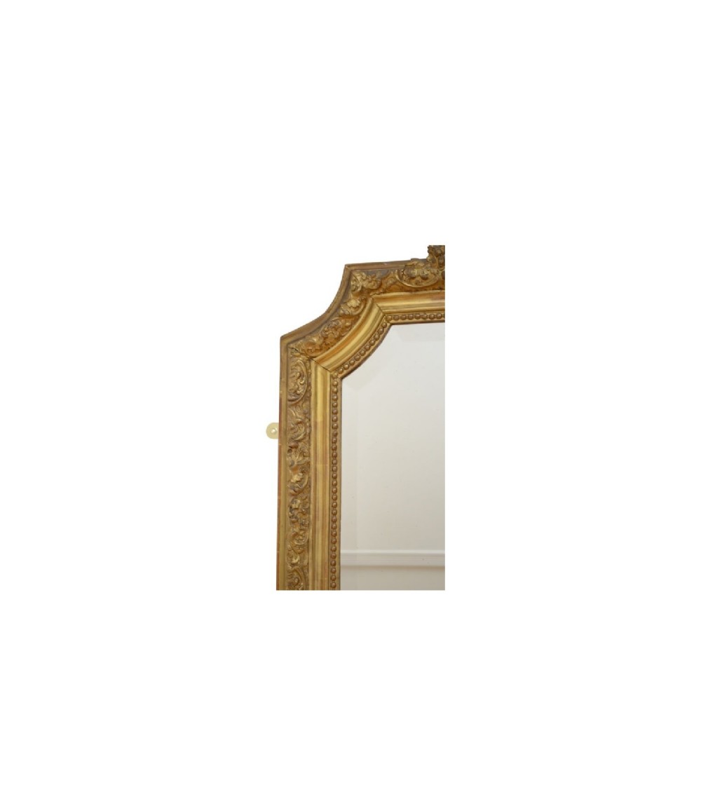 A tall French giltwood wall mirror featuring a carved foliate crest and a moulded gold frame. View XIV