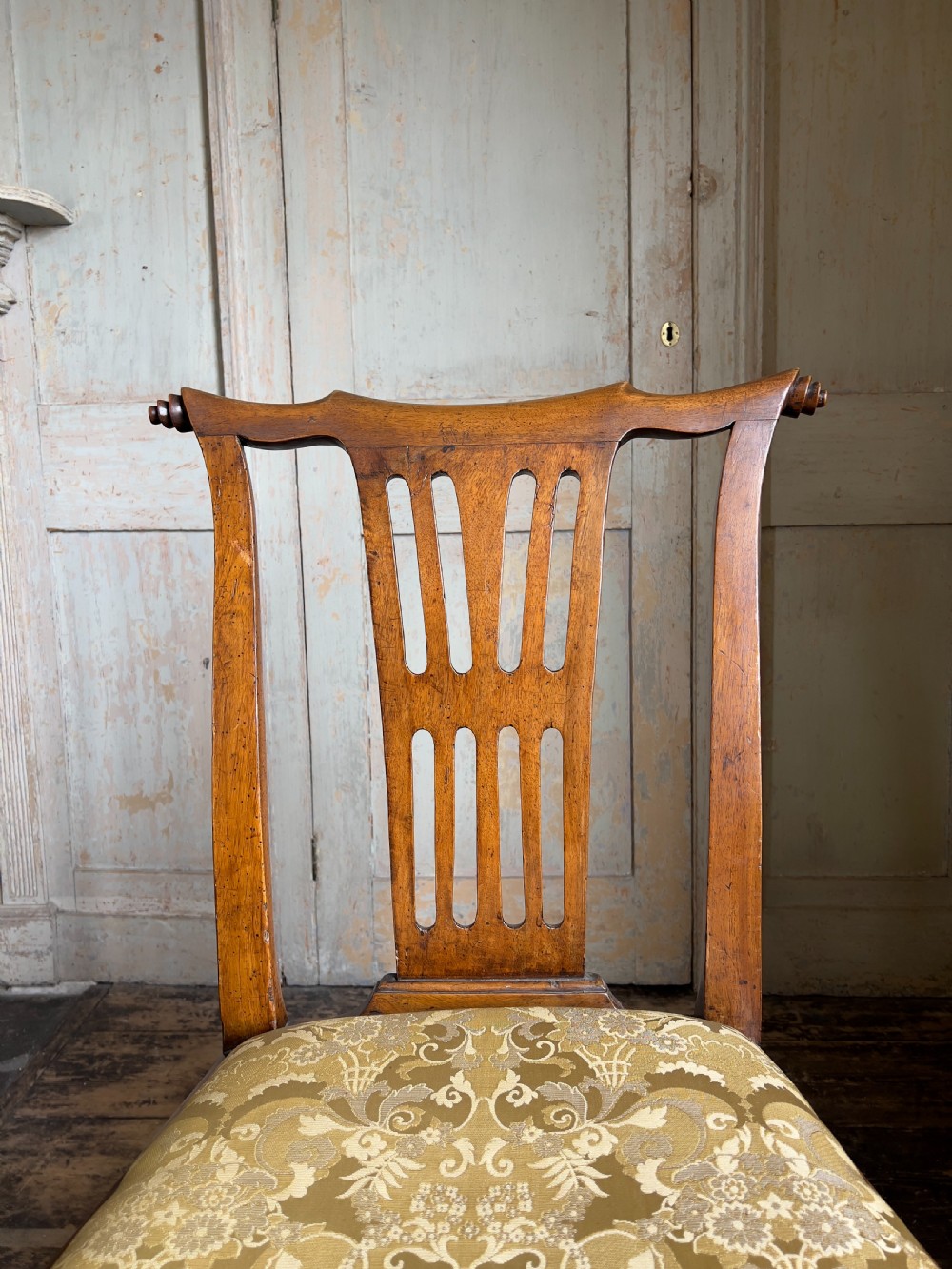 A George II period walnut side chair featuring a carved splat back, yellow damask seat cushion, and cabriole legs with claw-and-ball feet. View III
