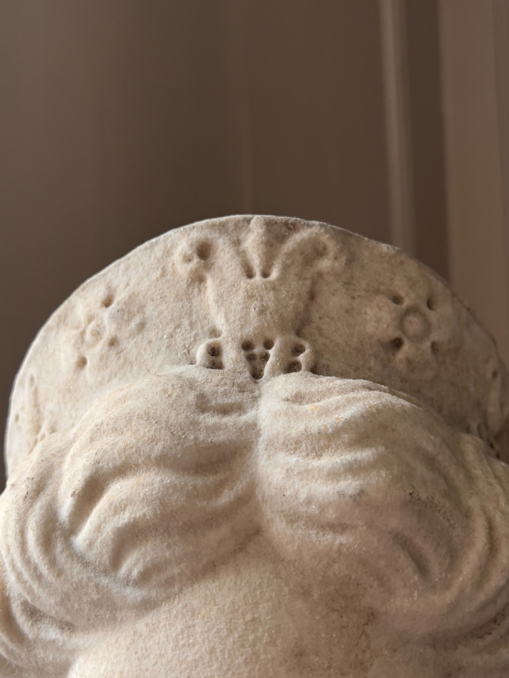 A carved marble classical bust depicting the head of Juno with wavy hair under a diadem crown, mounted on a square black pedestal. View VII