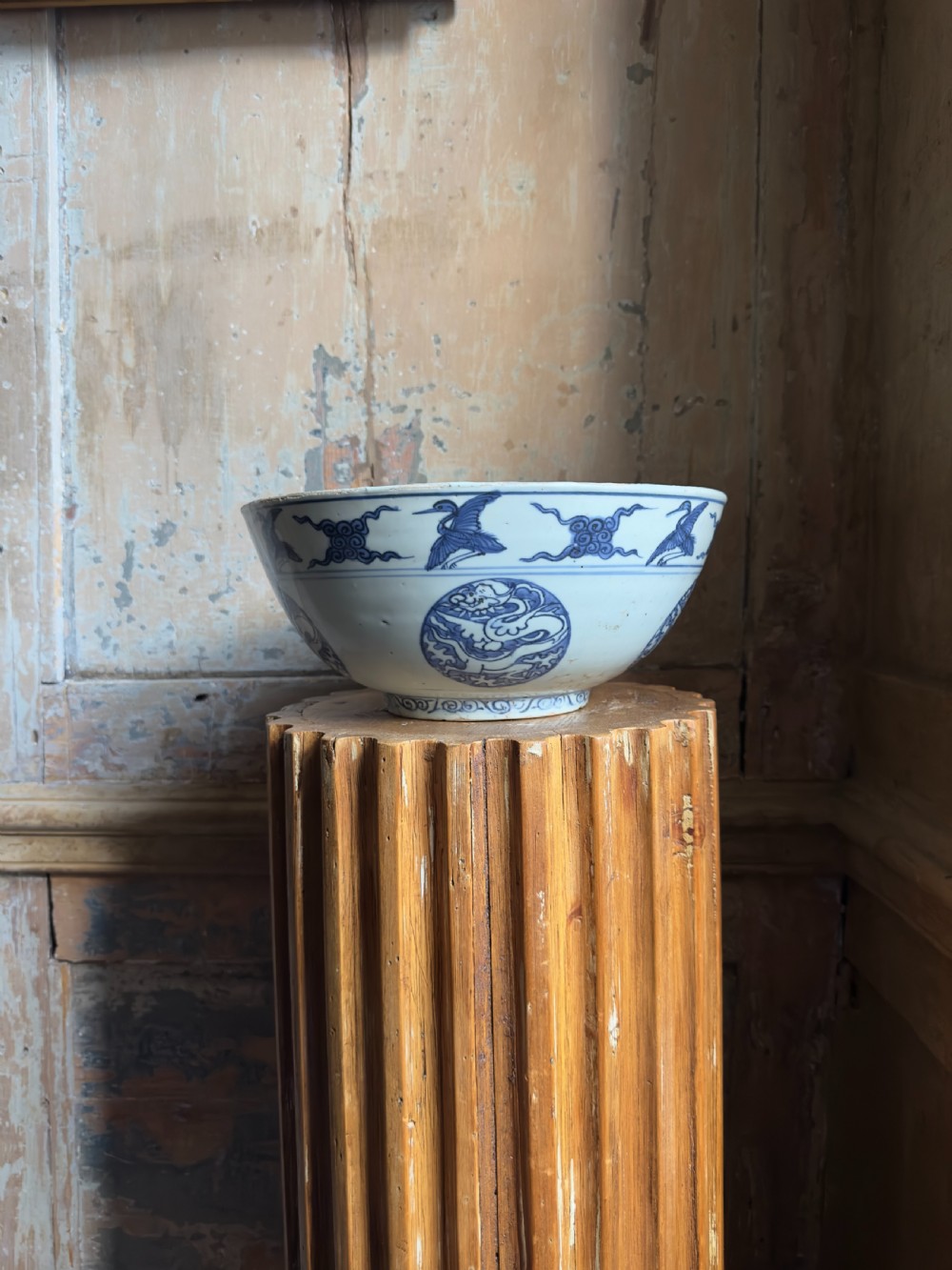 A large mid-16th century Chinese blue and white porcelain bowl decorated with underglaze hand-painted motifs of flying cranes and dragon medallions. View II