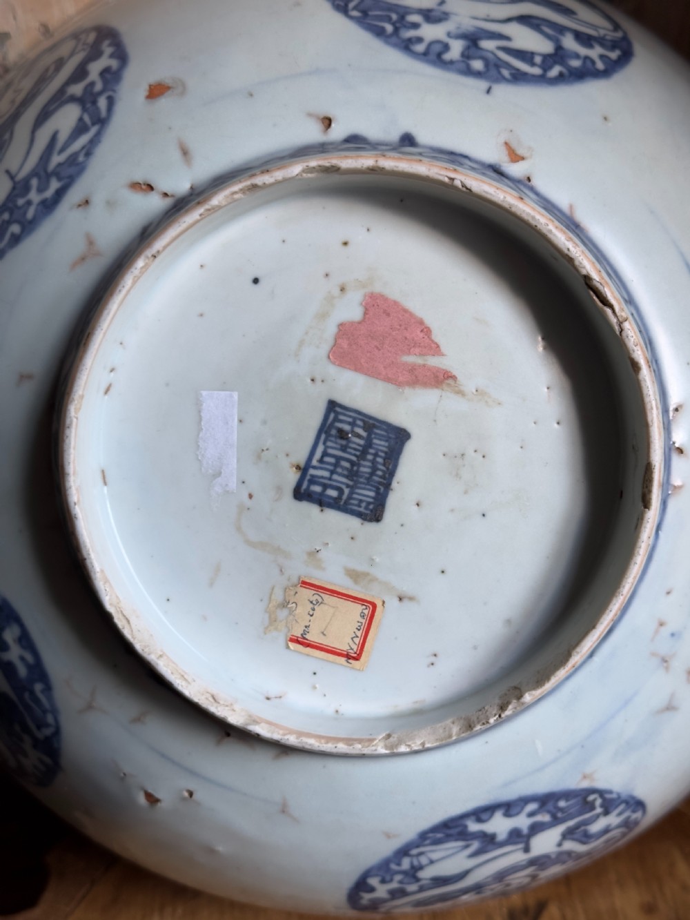 A large mid-16th century Chinese blue and white porcelain bowl decorated with underglaze hand-painted motifs of flying cranes and dragon medallions. View III