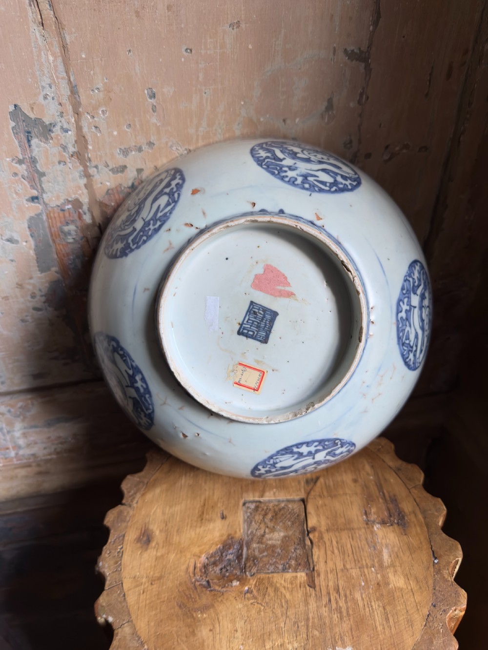 A large mid-16th century Chinese blue and white porcelain bowl decorated with underglaze hand-painted motifs of flying cranes and dragon medallions. View IV