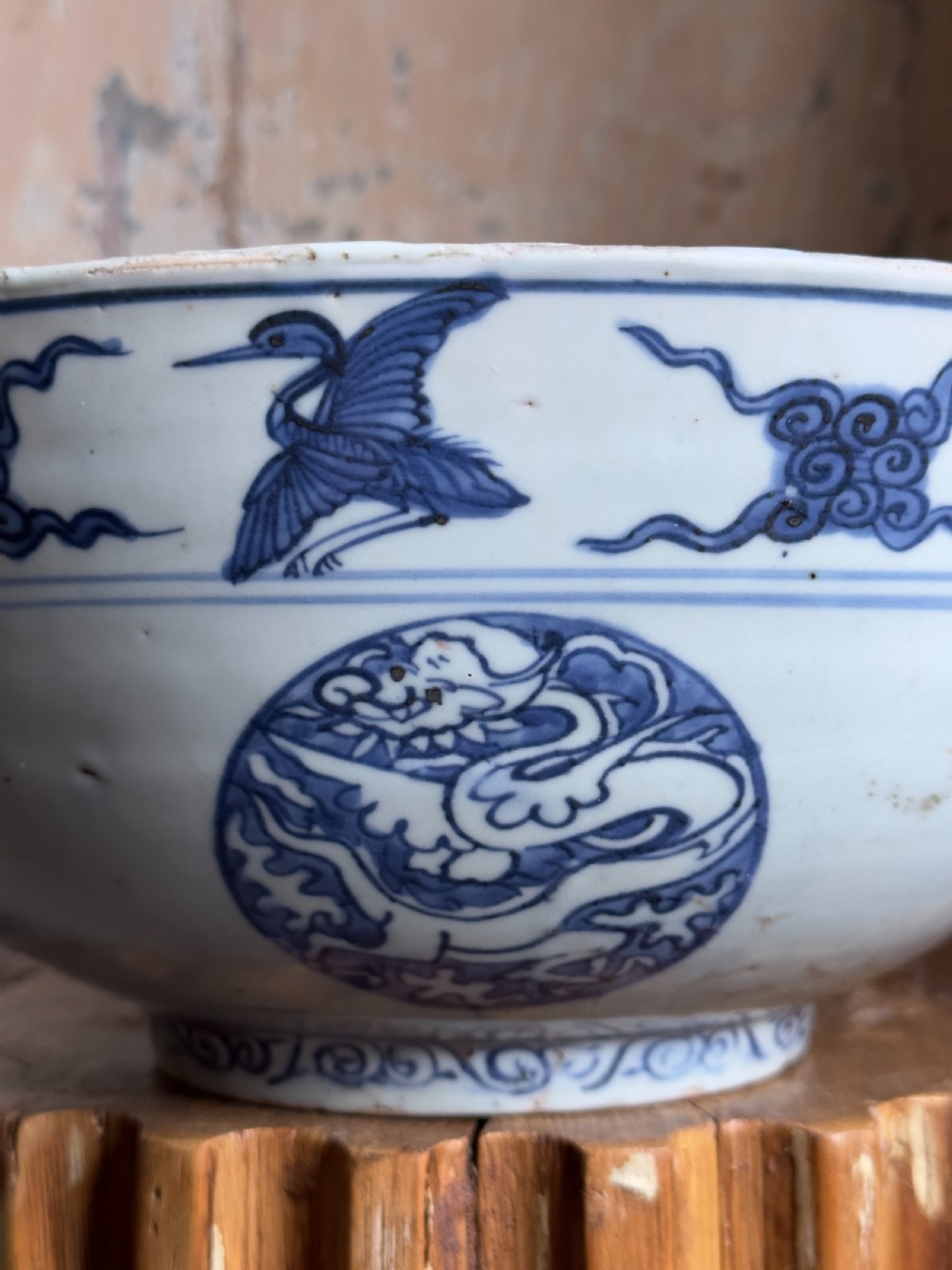 A large mid-16th century Chinese blue and white porcelain bowl decorated with underglaze hand-painted motifs of flying cranes and dragon medallions. View V