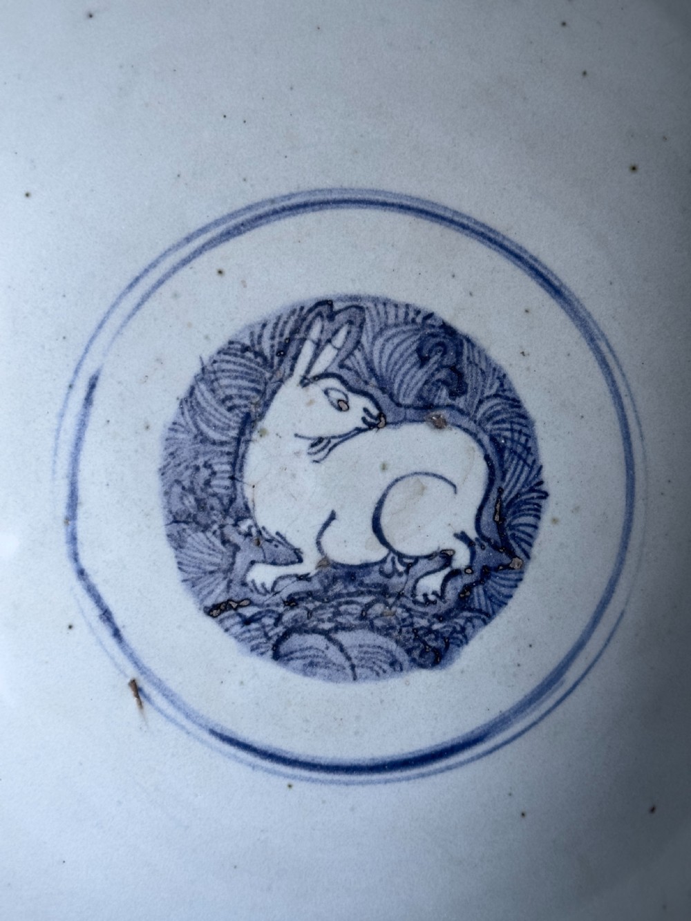 A large mid-16th century Chinese blue and white porcelain bowl decorated with underglaze hand-painted motifs of flying cranes and dragon medallions. View VI
