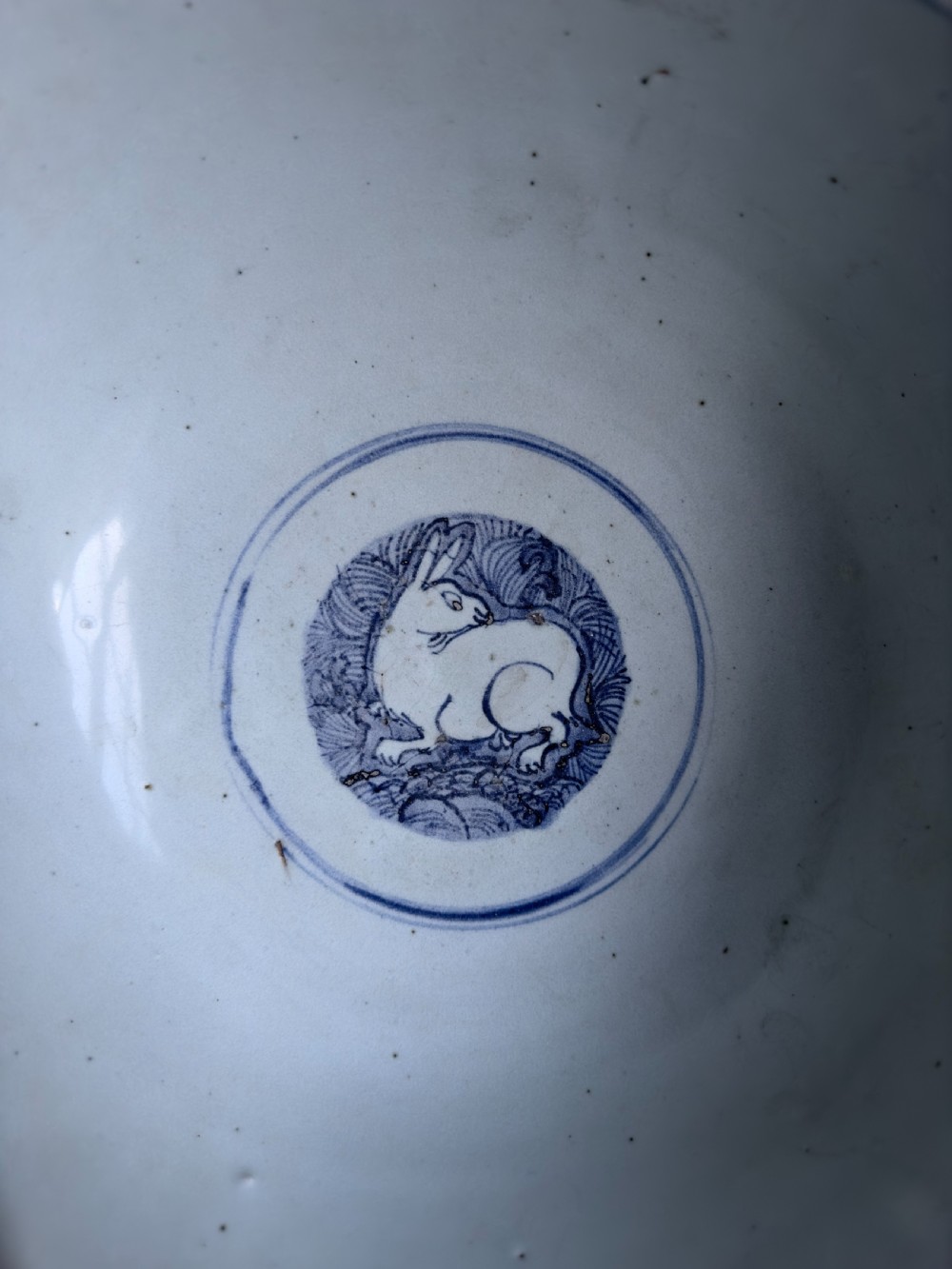 A large mid-16th century Chinese blue and white porcelain bowl decorated with underglaze hand-painted motifs of flying cranes and dragon medallions. View VII