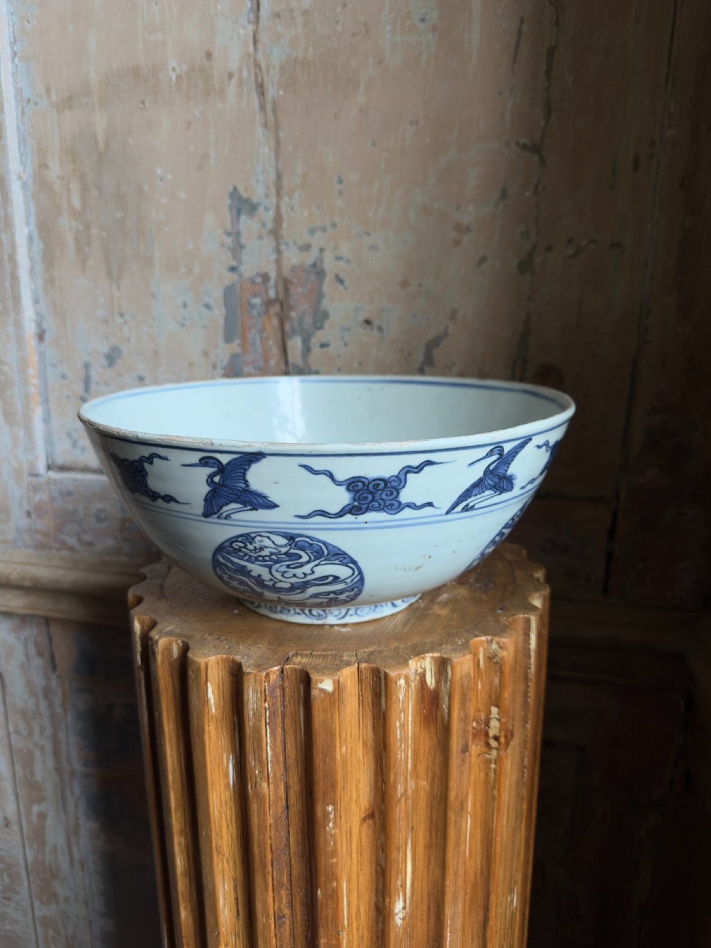 A large mid-16th century Chinese blue and white porcelain bowl decorated with underglaze hand-painted motifs of flying cranes and dragon medallions. View VIII
