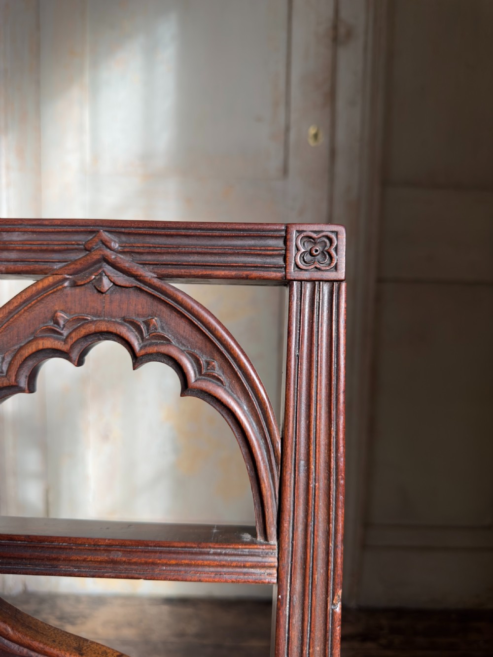An antique Georgian mahogany side chair featuring carved Gothic tracery in the backrest and turned legs. View IV