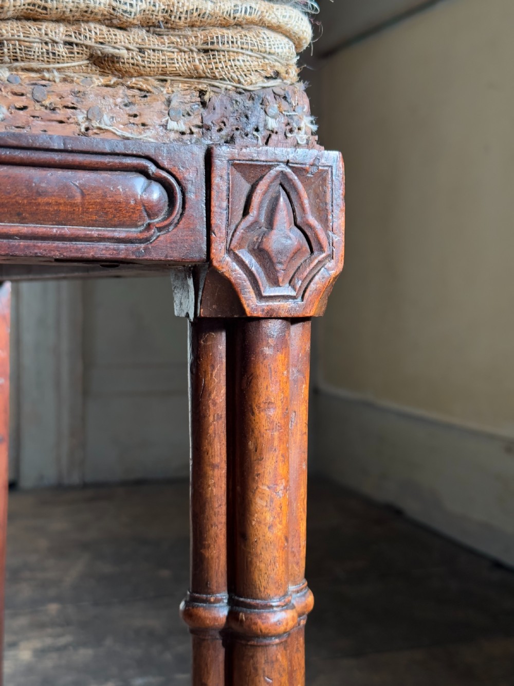 An antique Georgian mahogany side chair featuring carved Gothic tracery in the backrest and turned legs. View VII