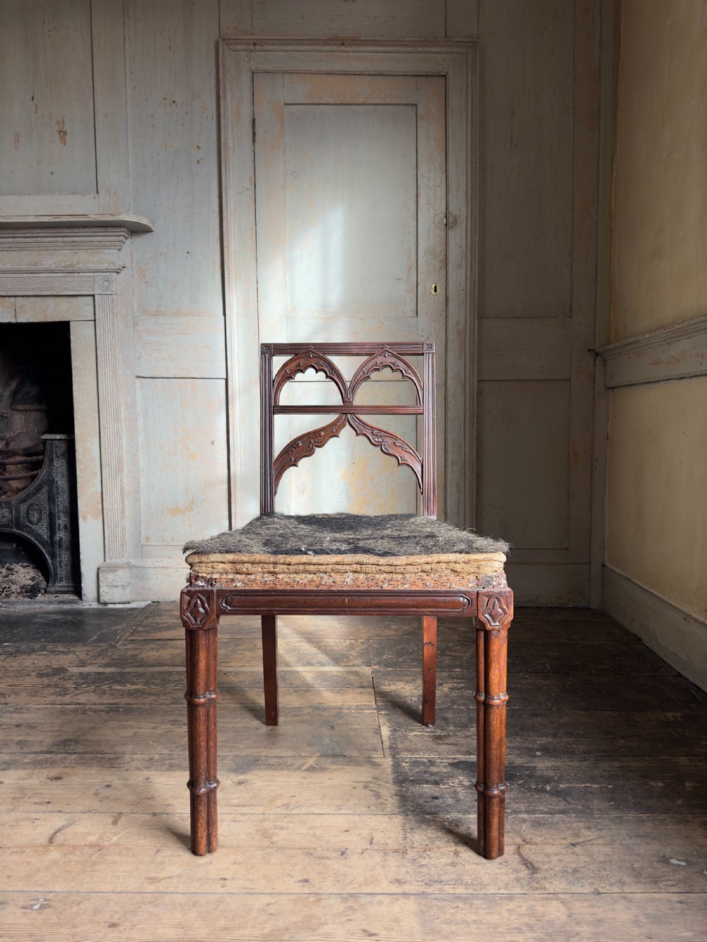 An antique Georgian mahogany side chair featuring carved Gothic tracery in the backrest and turned legs. View IX