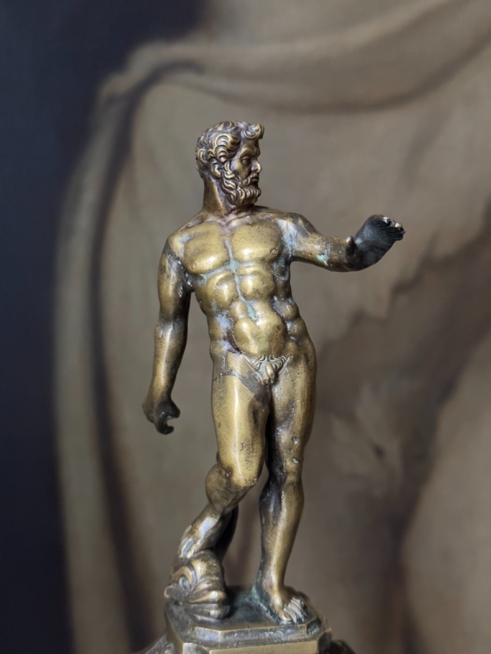 An 18th-century bronze statuette depicting the classical figure Neptune standing in contrapposto on a detailed pedestal and dark marble base. View II