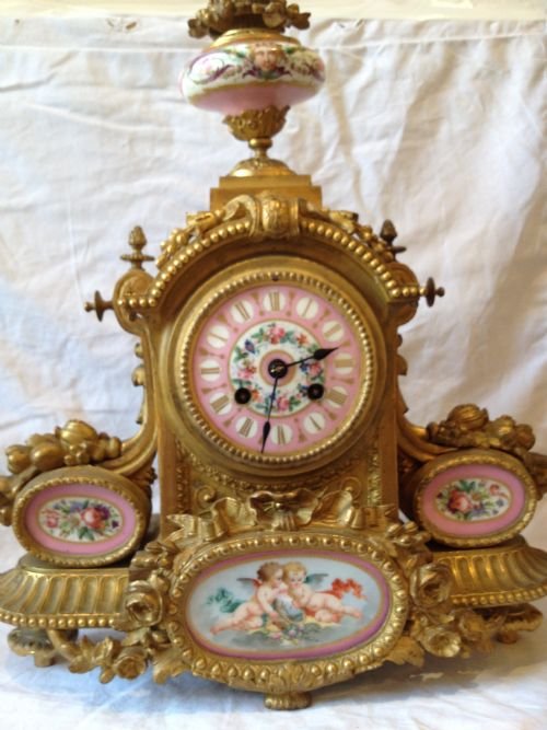 A Louis XVI Ormolu Mantle Clock with Sevres Panels