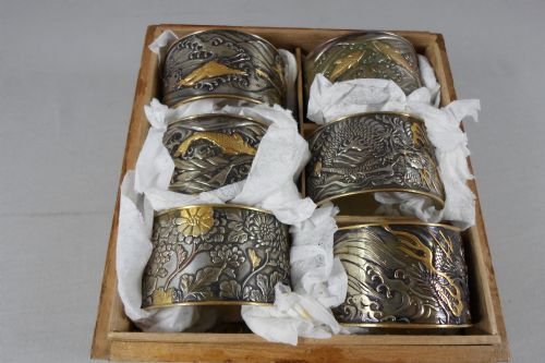 fig 1. SET OF SIX JAPANESE MIXED METAL NAPKIN RINGS IN TOMOBAKO
