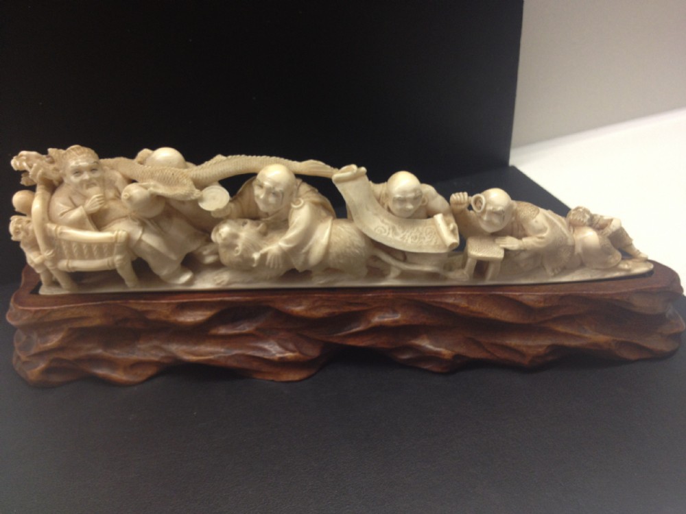 JAPANESE IVORY TUSK OKIMONO ON HARDWOOD STAND SIGNED