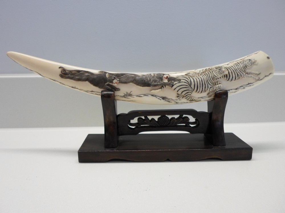 JAPANESE IVORY TUSK ON STAND LIONS AND ZEBRA