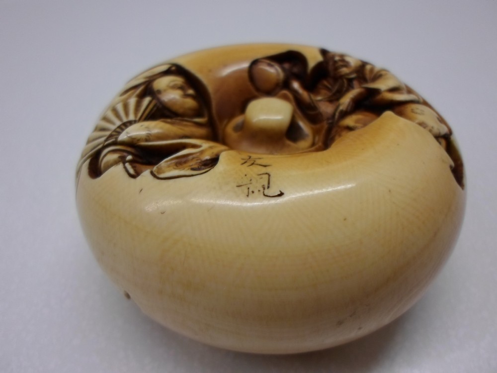 AN OVERSIZED JAPANESE IVORY MANJU NETSUKE SIGNED TOMOCHIKA View III