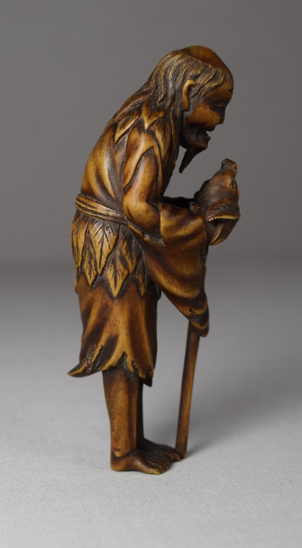 JAPANESE WOODEN NETSUKE OF TOBOSAKU (PEACH SENNIN) View III