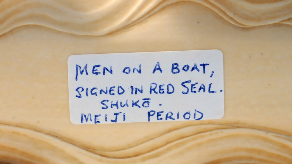 A HUMEROUS JAPANESE IVORY OKIMONO PLEASURE BOAT SIGNED 