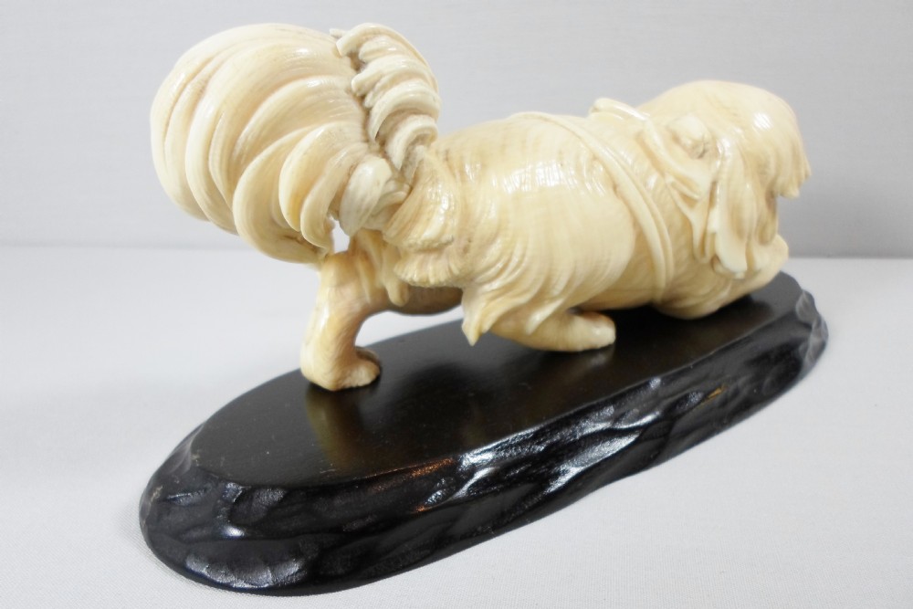 A CHARMING JAPANESE IVORY OKIMONO OF A PEKINGESE DOG View III