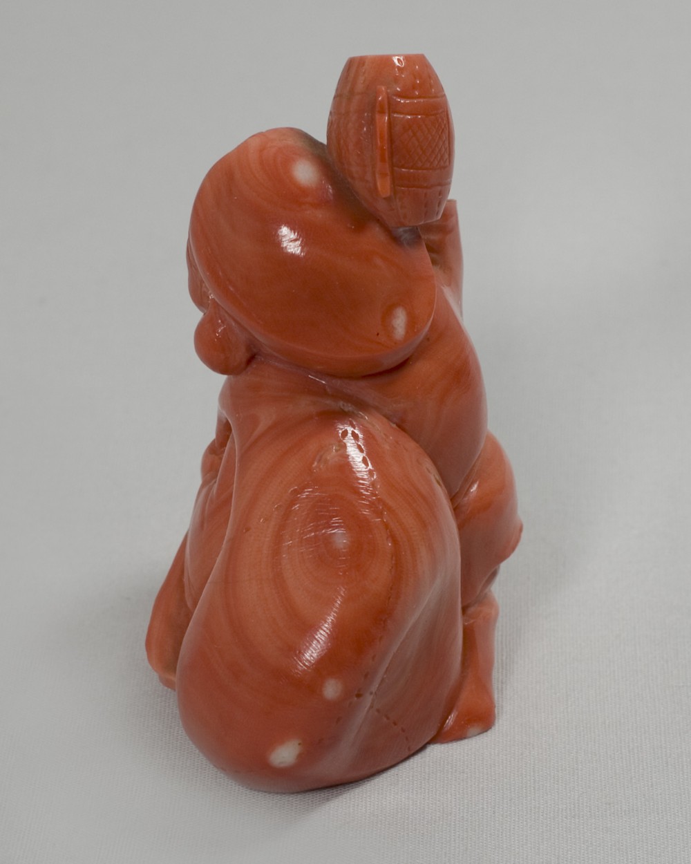 A RARE JAPANESE CARVED CORAL OKIMONO OF DAIKOKU View III