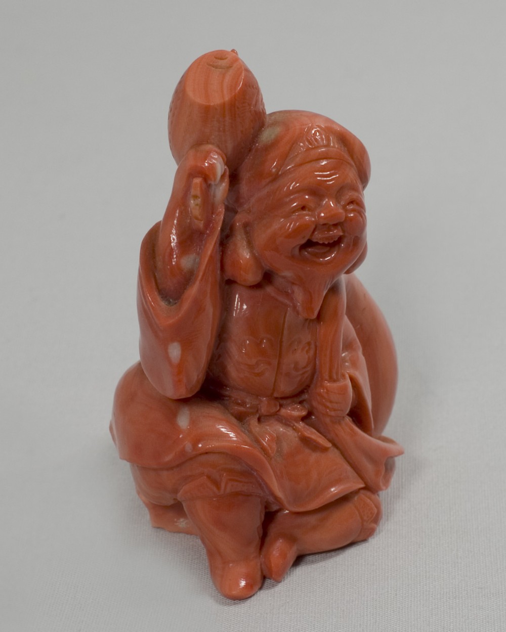 A RARE JAPANESE CARVED CORAL OKIMONO OF DAIKOKU View VI