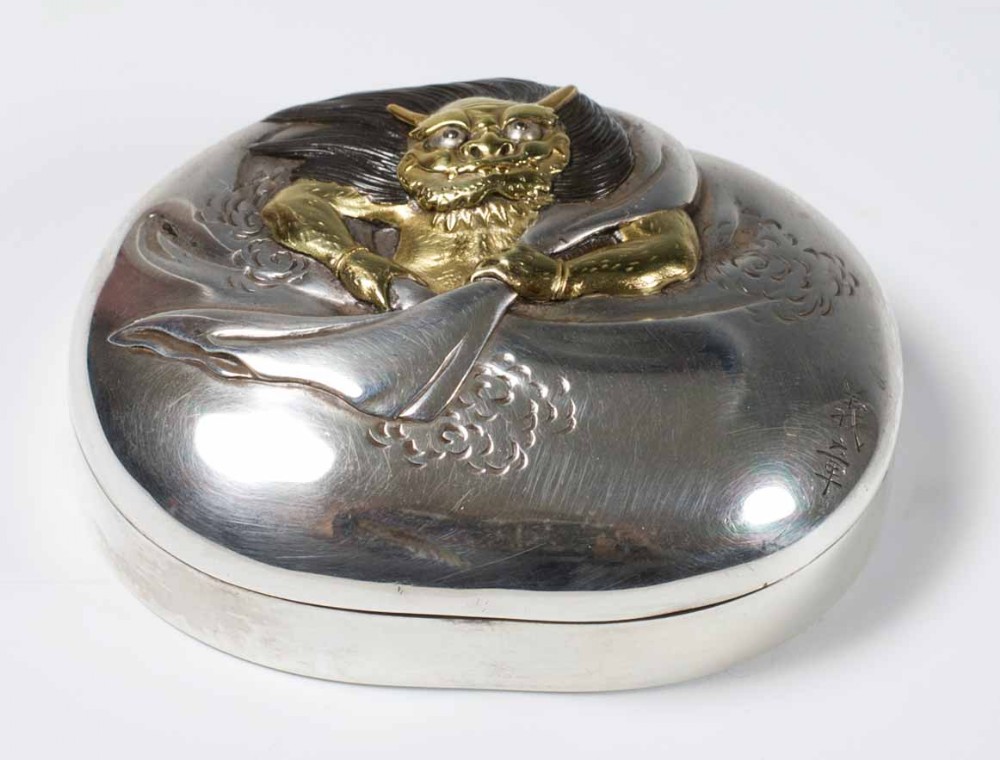 A SOLID SILVER JAPANESE  BOX AND COVER DEPICTING SHOKI View II