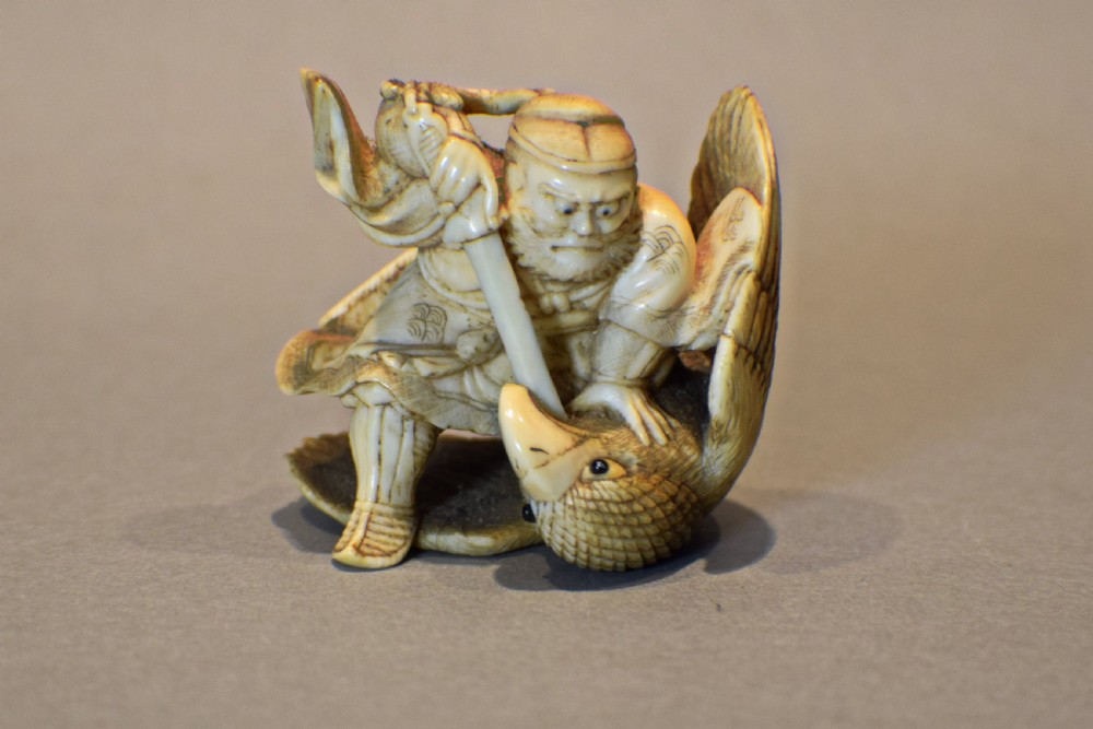 JAPANESE IVORY OKIMONO OF SAMURAI INO HAYATA SLAYING THE GIANT BIRD