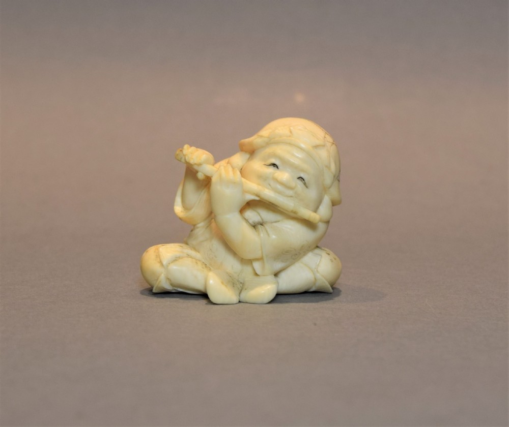 a japanese ivory okimono of a boy playing flute signed kogyoku - CATEGORY: ANTIQUE MISCELLANEOUS - DATED 1890