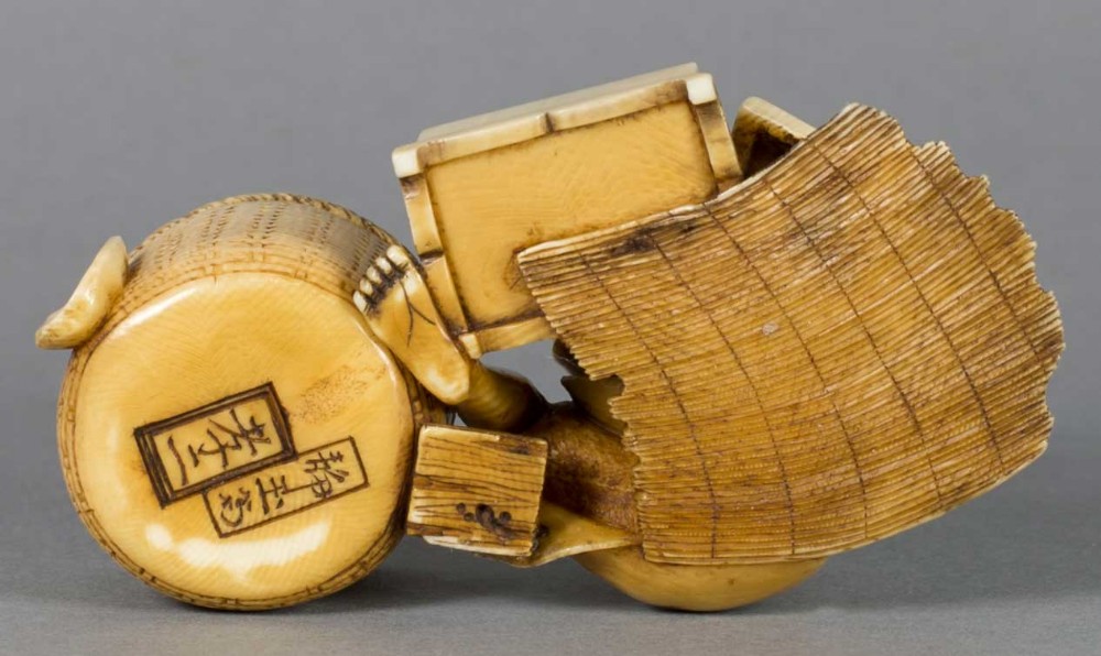A FUN JAPANESE IVORY OKIMONO OF A BOY WITH HIS TOYS View VI