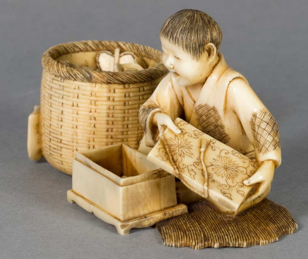 A FUN JAPANESE IVORY OKIMONO OF A BOY WITH HIS TOYS View VII