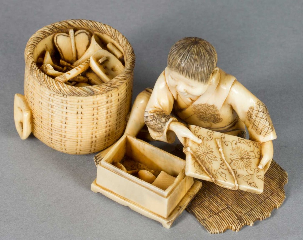 A FUN JAPANESE IVORY OKIMONO OF A BOY WITH HIS TOYS View VIII