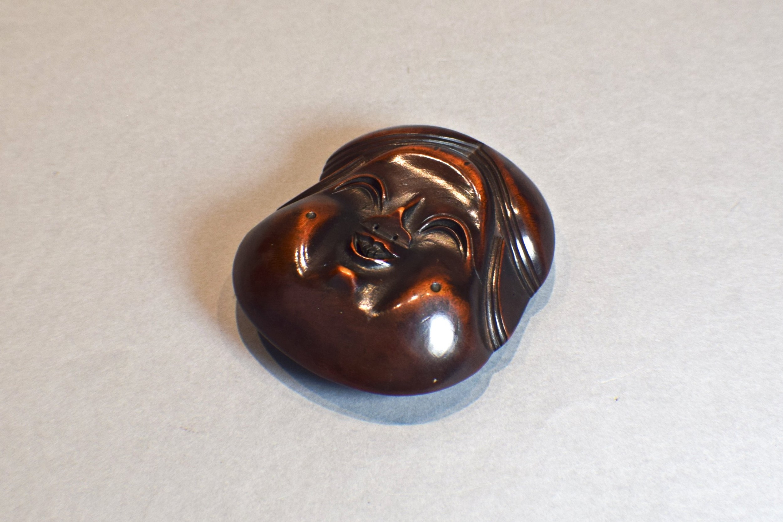 A LARGE AND CHARMING JAPANESE WOODEN NOH MASK NETSUKE OF OKAME - SIGNED View VI