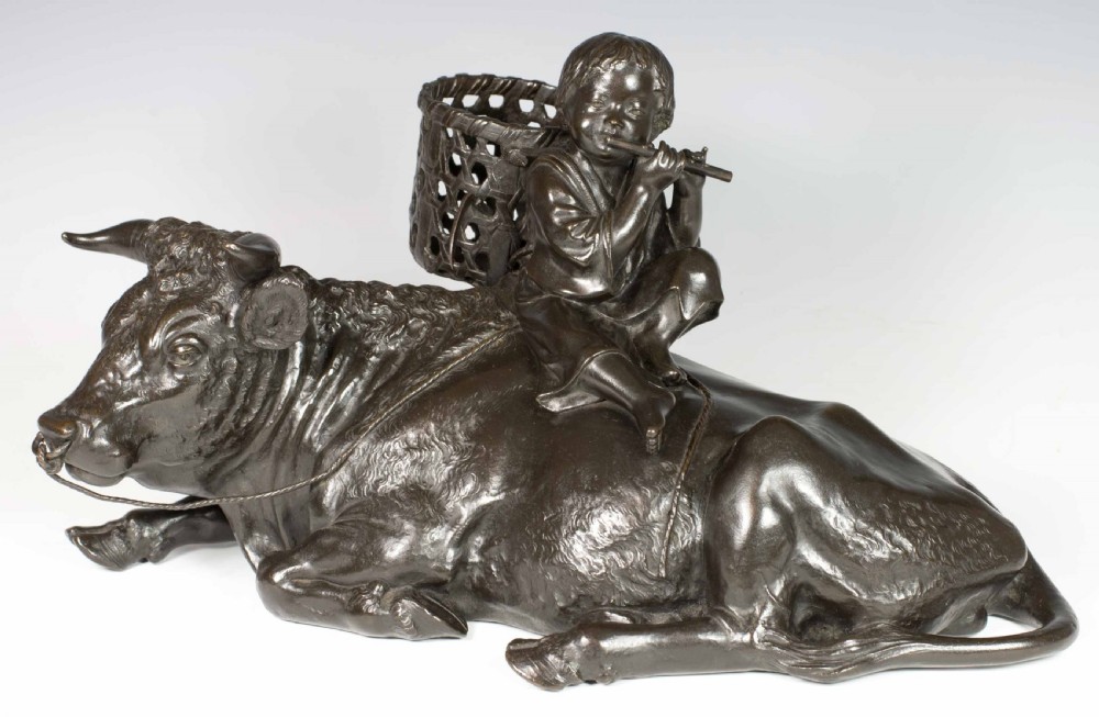 A FINE QUALITY SIGNED JAPANESE BRONZE OKIMONO BOY UPON AN OXEN