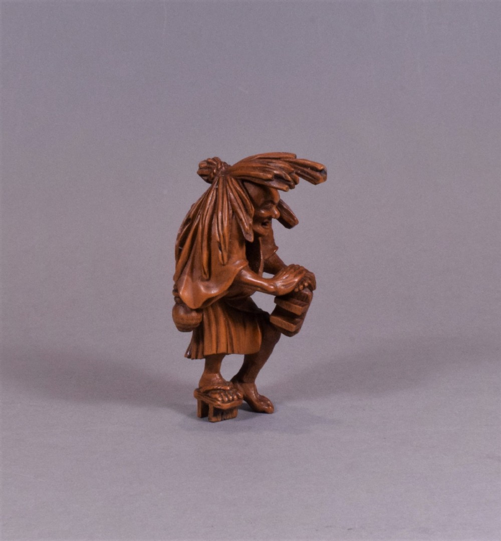 A WELL CARVED JAPANESE CARVED WOODEN NETSUKE - ABURA BOZU - THE OIL THIEF View V