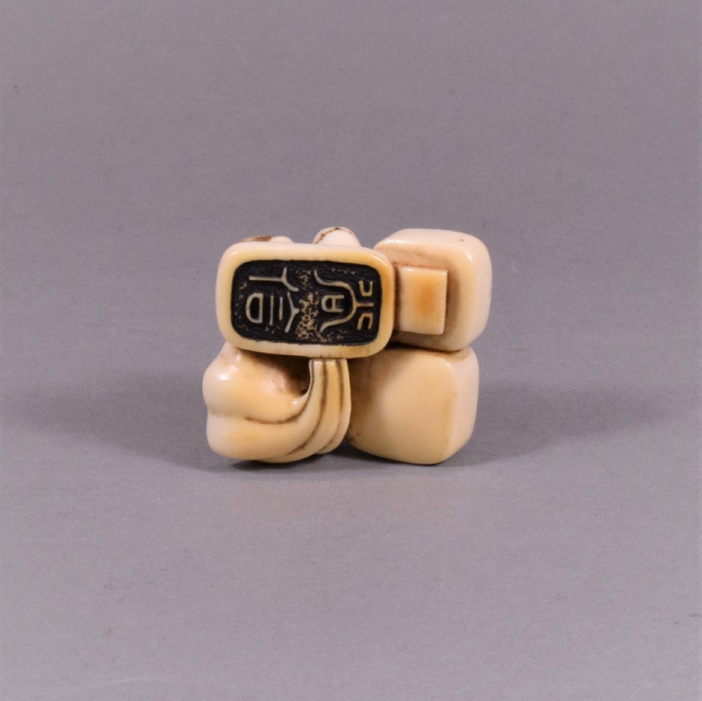 A JAPANESE EDO PERIOD IVORY NETSUKE OF SEALS - SHI SHI DOG View VII