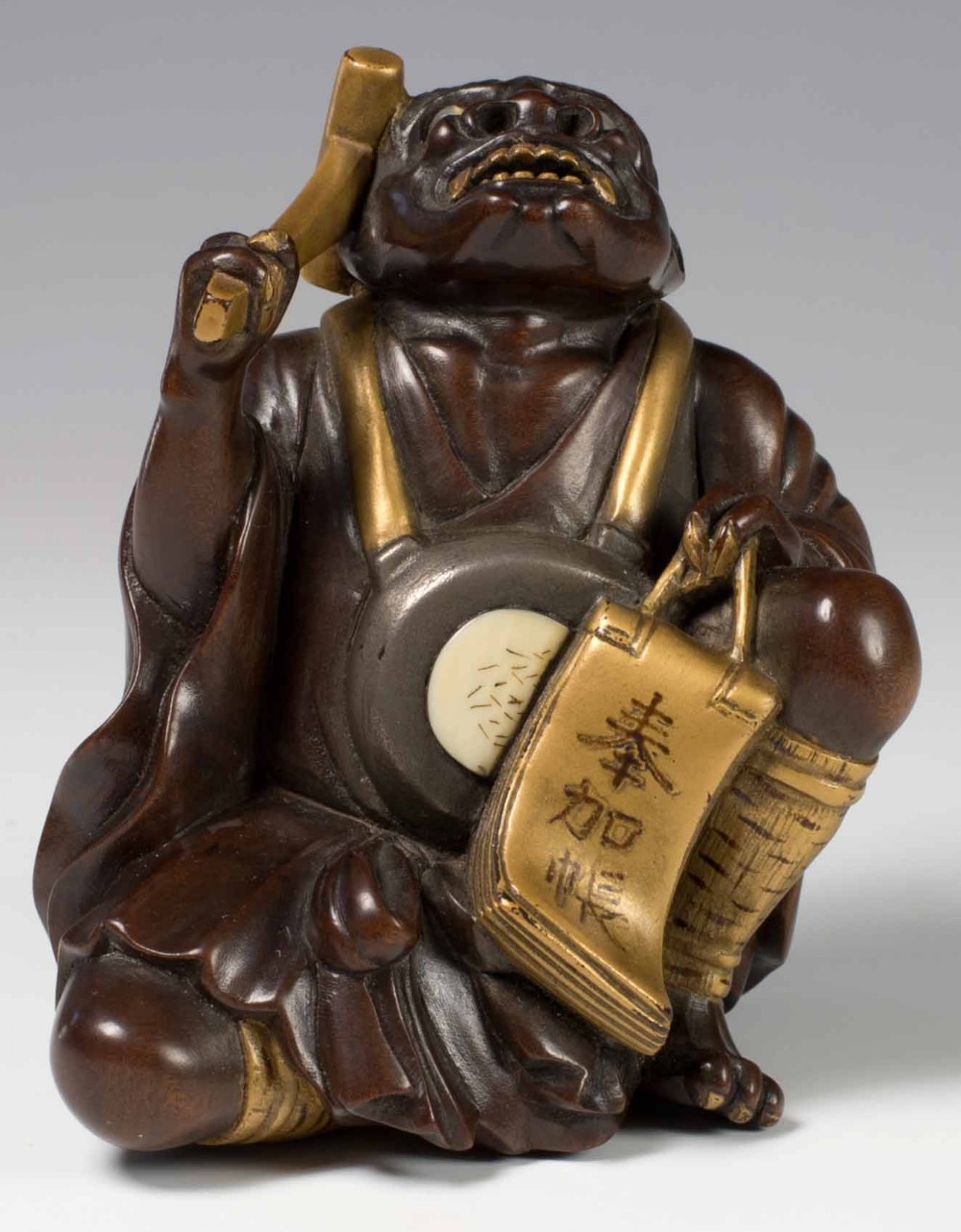 A FINELY CARVED JAPANESE HARDWOOD AND GOLD LACQUER ONI OKIMONO View II