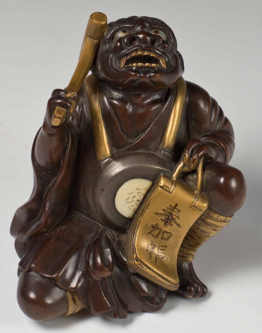 A FINELY CARVED JAPANESE HARDWOOD AND GOLD LACQUER ONI OKIMONO View III