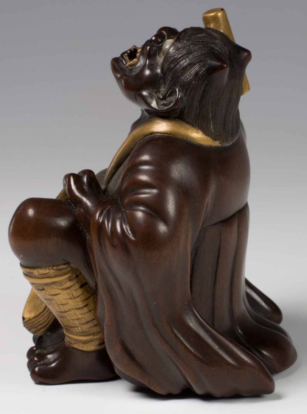 A FINELY CARVED JAPANESE HARDWOOD AND GOLD LACQUER ONI OKIMONO View V