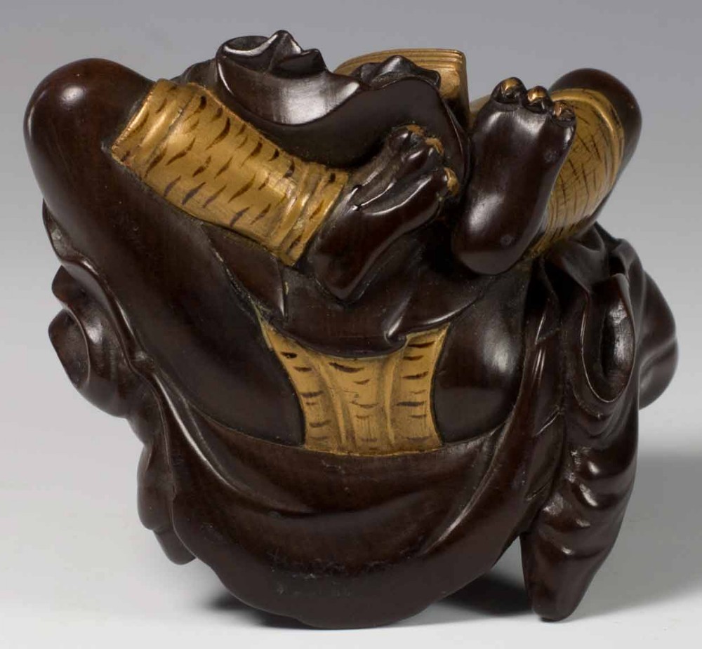 A FINELY CARVED JAPANESE HARDWOOD AND GOLD LACQUER ONI OKIMONO View VIII