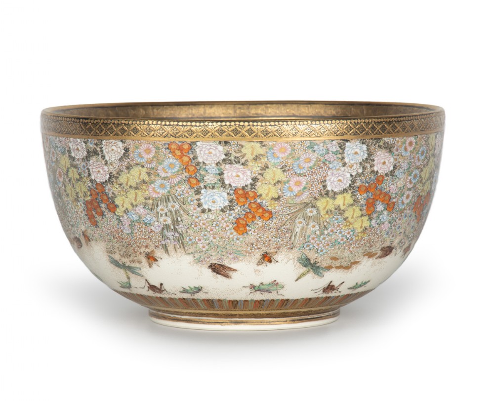 A deep Japanese Satsuma earthenware bowl featuring densely painted floral chrysanthemums, insect motifs near the base, and gilded borders on a cream background. View II