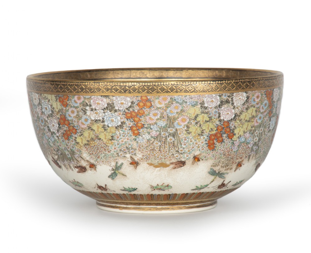 A deep Japanese Satsuma earthenware bowl featuring densely painted floral chrysanthemums, insect motifs near the base, and gilded borders on a cream background. View III