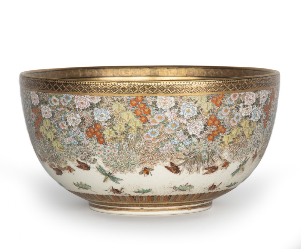 A deep Japanese Satsuma earthenware bowl featuring densely painted floral chrysanthemums, insect motifs near the base, and gilded borders on a cream background. View IV