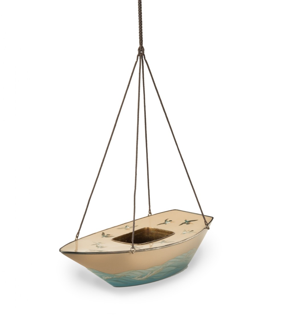 A boat-shaped Japanese cloisonne enamel hanging incense burner featuring flying bird motifs against a cream backdrop with wave details along the base, suspended by braided cords. View II