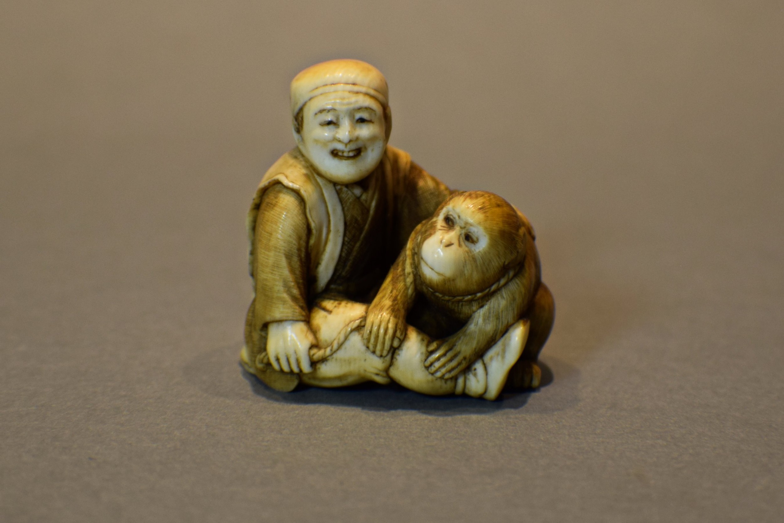 a charming japanese ivory okimono of a seated monkey sarumawashi signed - CATEGORY: ANTIQUE MISCELLANEOUS - DATED 1900
