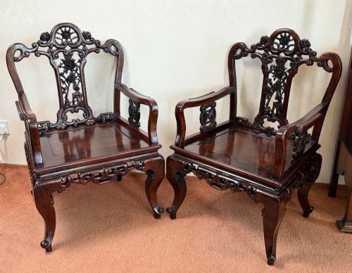 Pair of carved Chinese hardwood chairs.