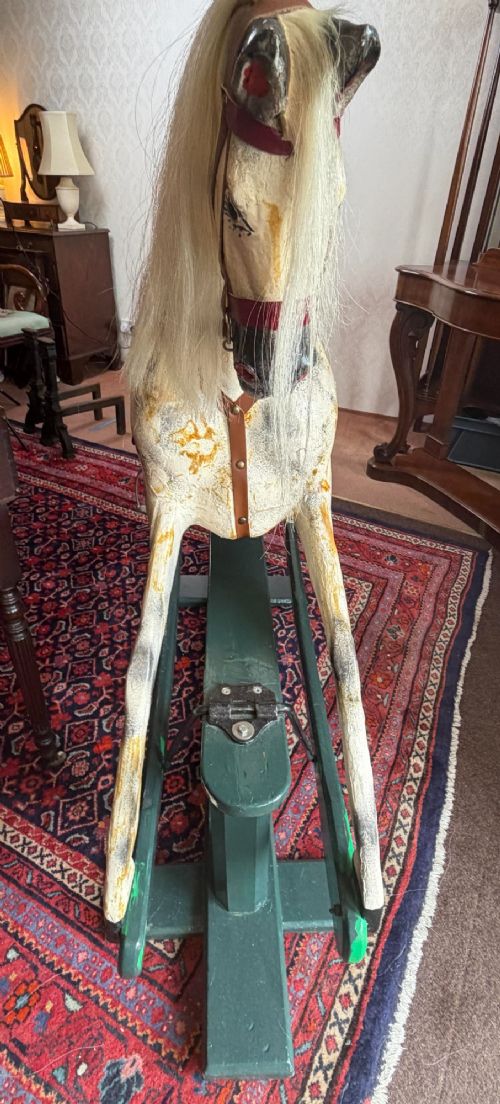 A 19th-century carved wooden dappled grey rocking horse with a leather saddle, horsehair mane, and dark green painted glider stand. View IX
