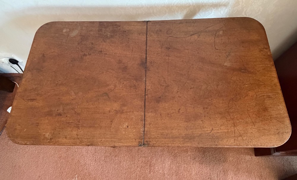 A warm brown wooden antique coaching table featuring a hinged rectangular top supported by curved X-frame legs and turned stretchers. View III